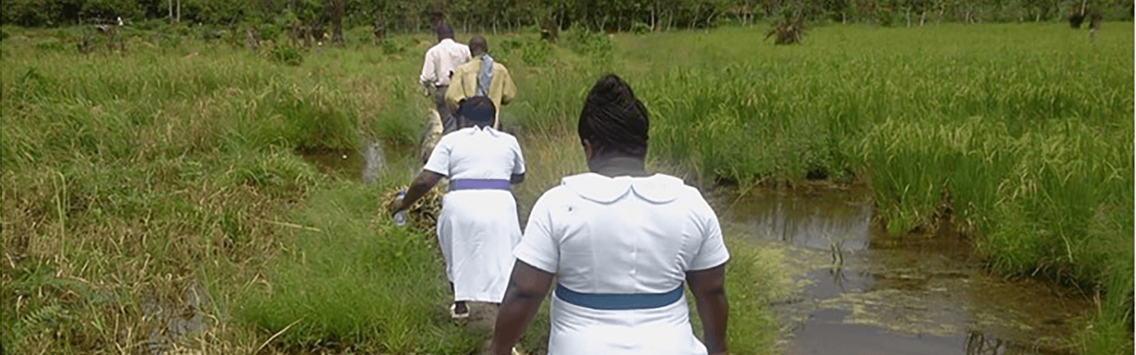 Ghana community health workers crossing difficult terrain