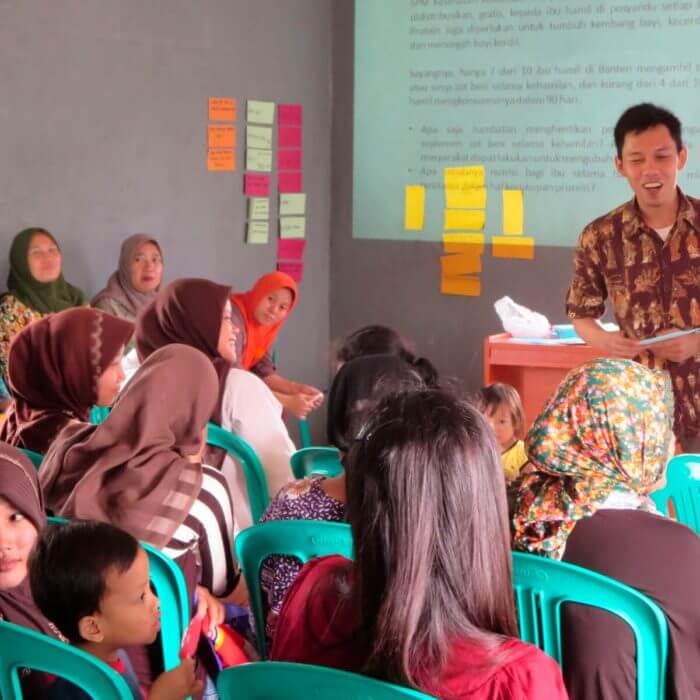 A community-based organization in Indonesia meets in a school