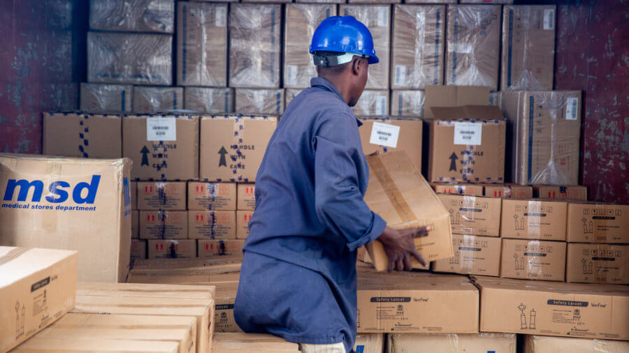 A man at Tanzania's Medical Stores Department loads a shipment onto a truck to be delivered.